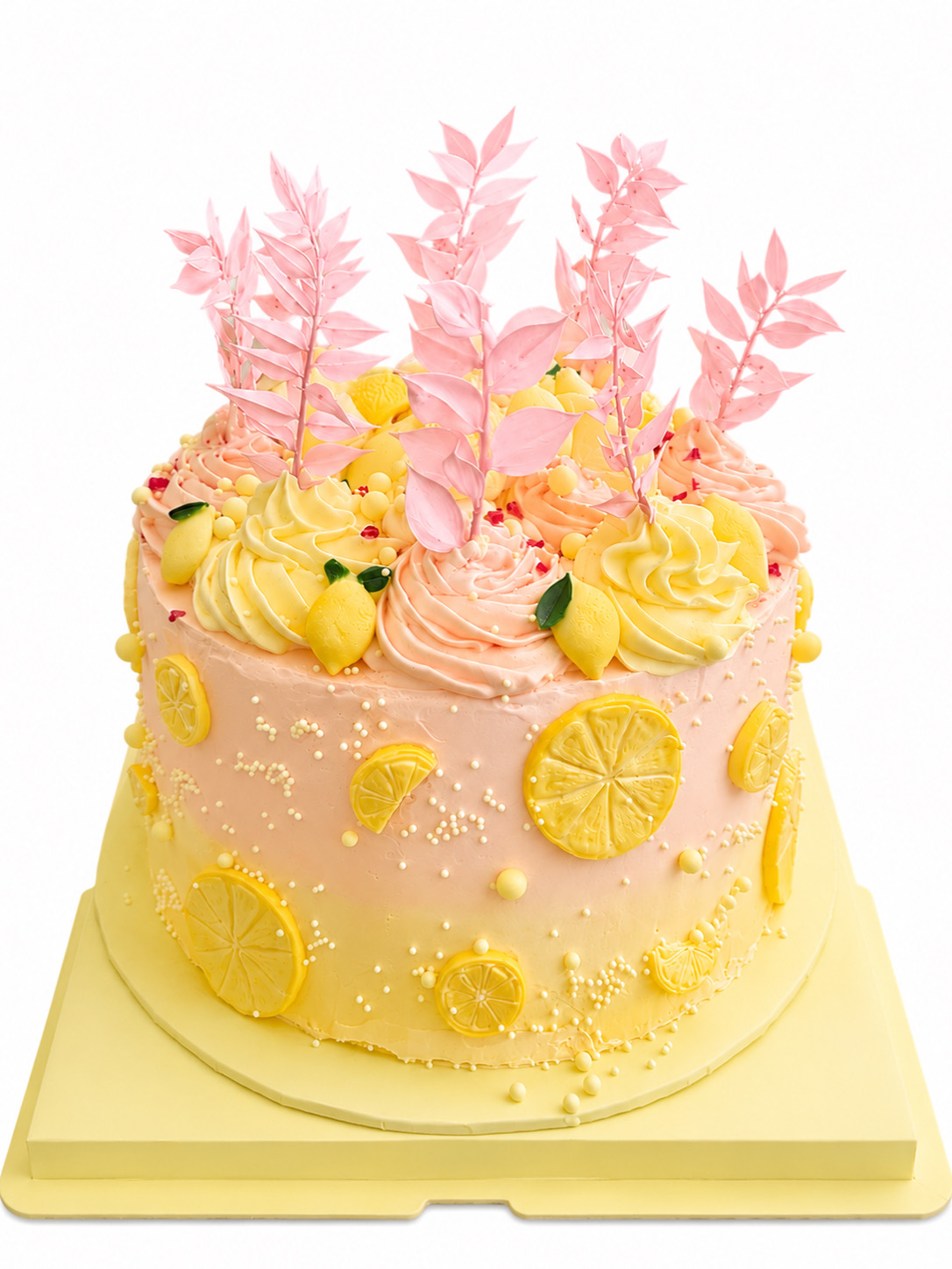 Pink and lemon buttercream cake with sugar lemon slices and pink leaf shards
