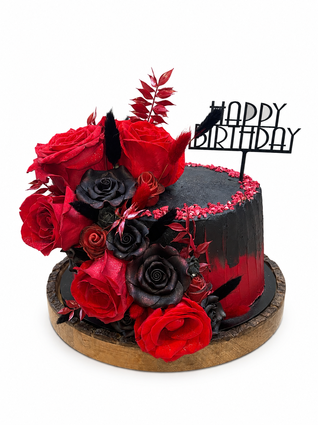 A black and red buttercream birthday cake decorated with fresh roses