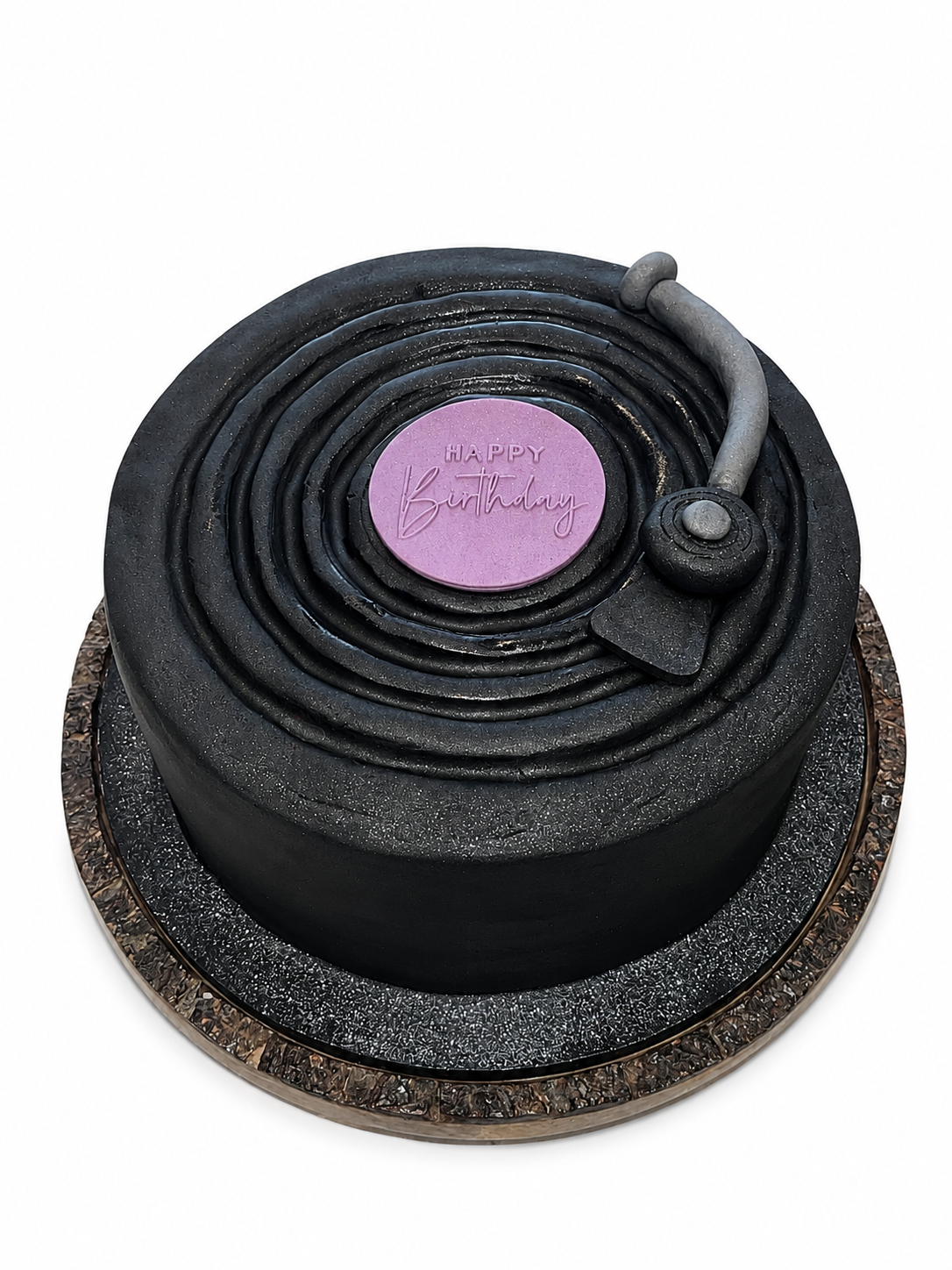 Black vinyl record cake with a pink Happy Birthday plaque